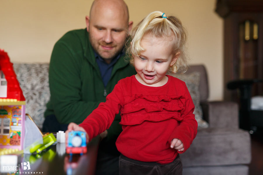 family photography - toddler playing with trains