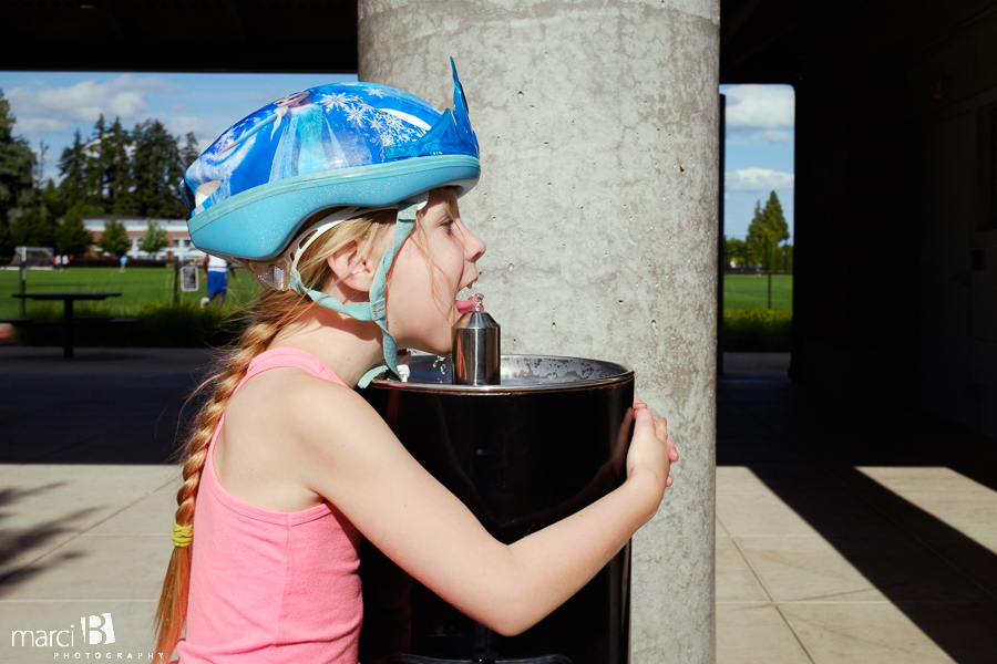 Girl drinking from fountain