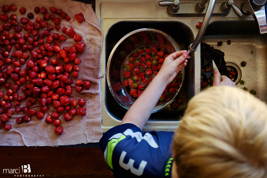 photos of boy washing strawberries