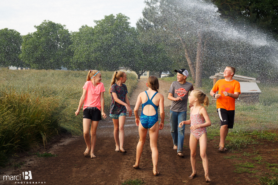kids playing in sprinkler - summer photos