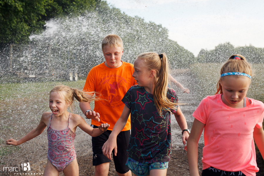 kids playing in sprinkler - summer photos