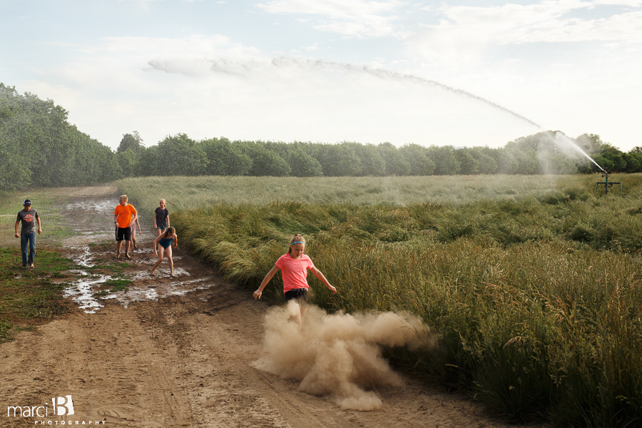 kids playing in sprinkler - summer photos - life on a farm