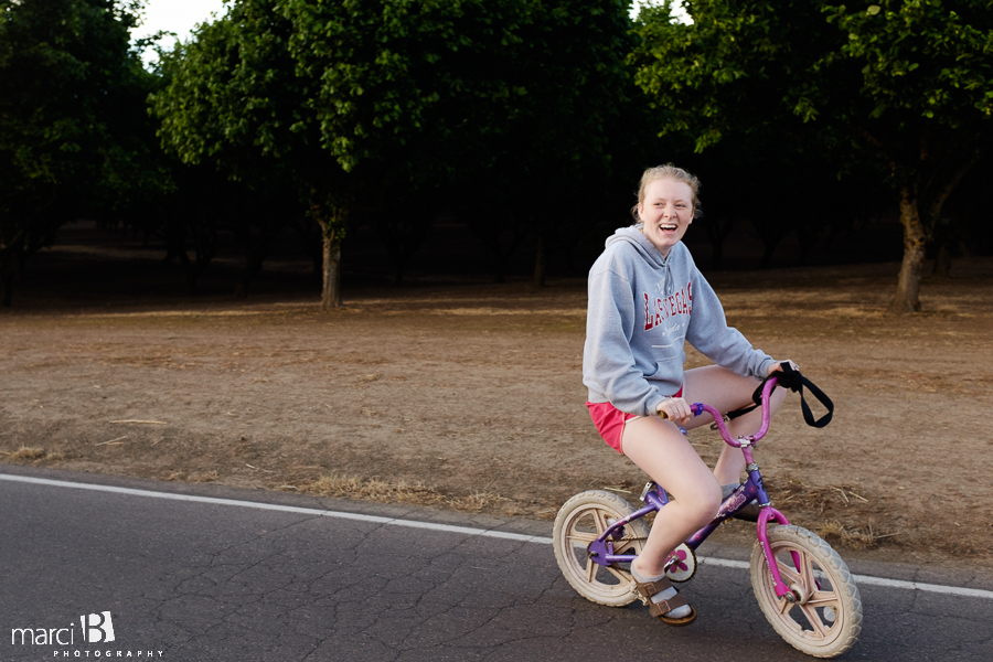 family bike rides - photo of teen on small bike - hazelnut orchard