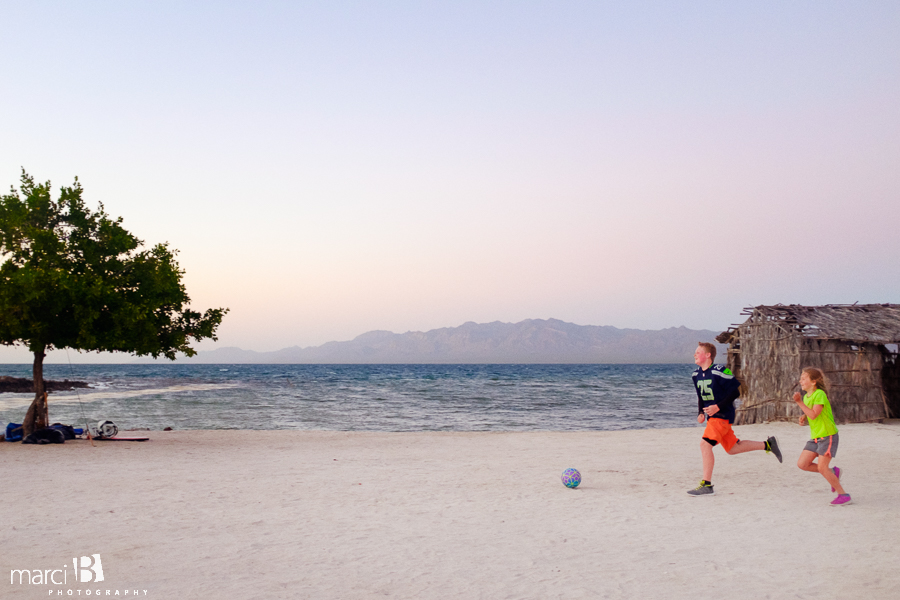 kids playing soccer on beach - childhood - Bahia Concepcion camping - Baja family road trip