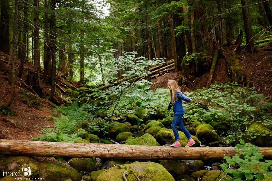 Camp photography - girl walking on log in woods