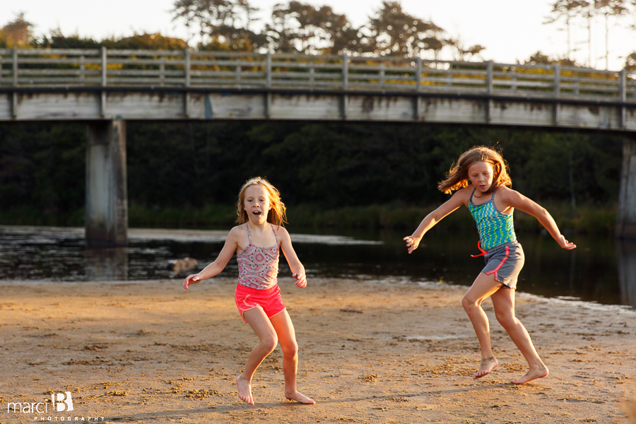 girls dancing on beach - golden light