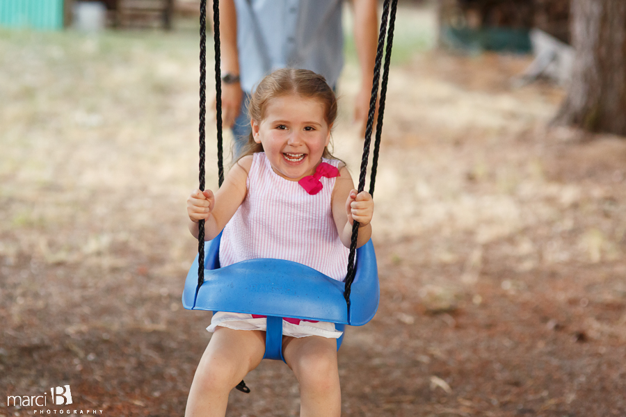 little girl swinging