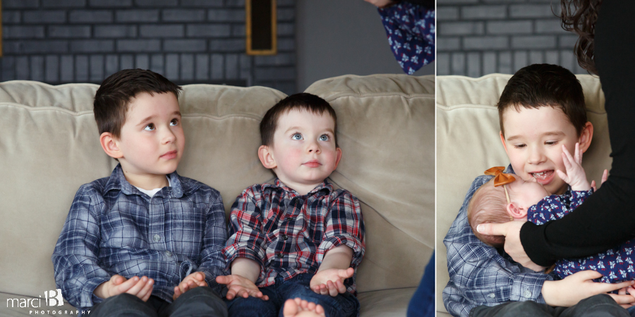 brothers hold newborn sister - newborn photography - siblings