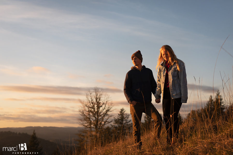 pacific northwest engaged couple watching the sunset