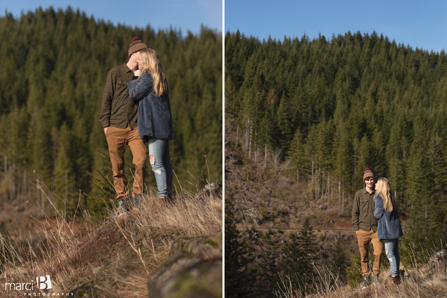 oregon engaged couple standing in the forest