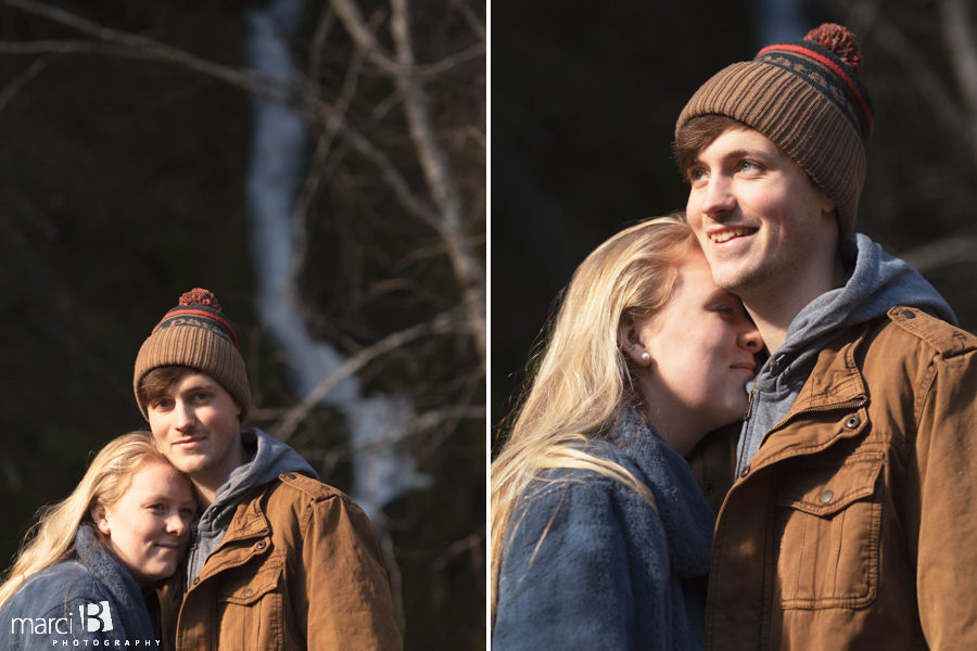 iconic pacific  northwest couple in front of waterfall