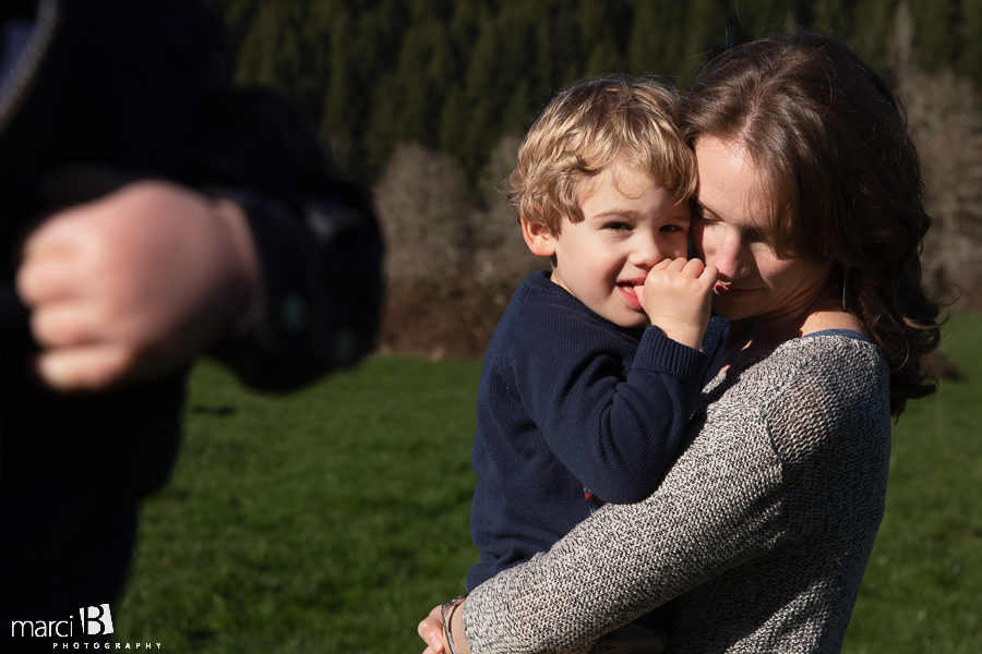 family photographer takes pictures of family with two young boys in Oregon Coast Range -  lifestyle photos of mother and son