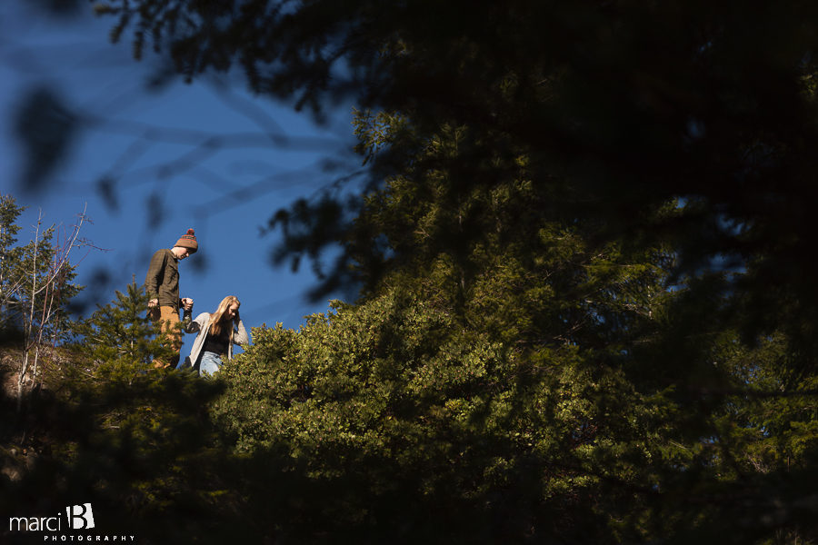 couple descending mountain rock in pacific northwest