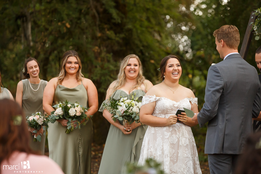 bride smiles at groom during ceremony