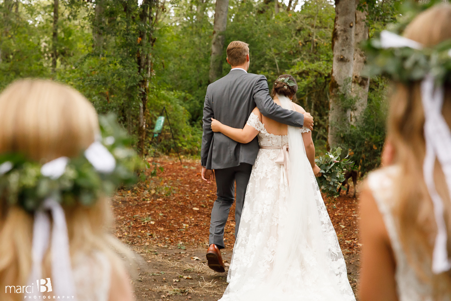 bride and groom walking from ceremony