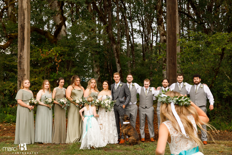 flower girls run to get pictures taken